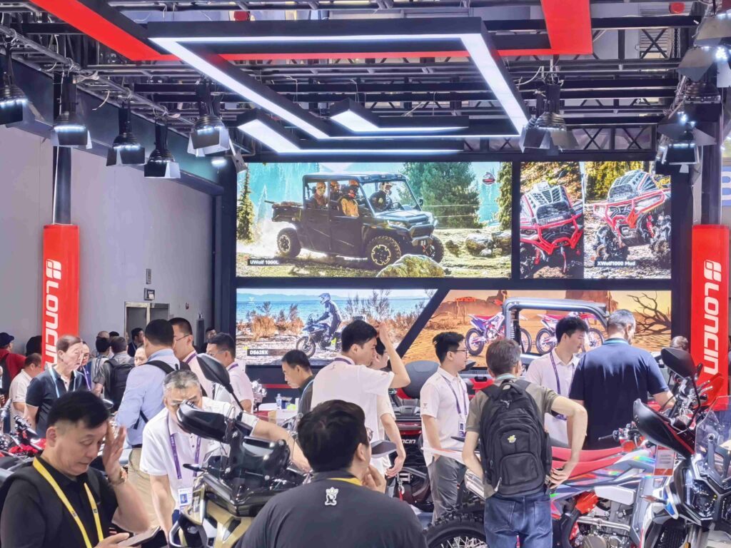 LONCIN ORV Makes A Surprise Appearance at the 139th Canton Fair 2 buyers inspecting LONCIN XWolf ATV details at exhibition