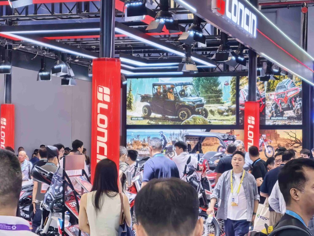 LONCIN ORV Makes A Surprise Appearance at the 139th Canton Fair 4 crowd viewing LONCIN ATV lineup at busy trade show