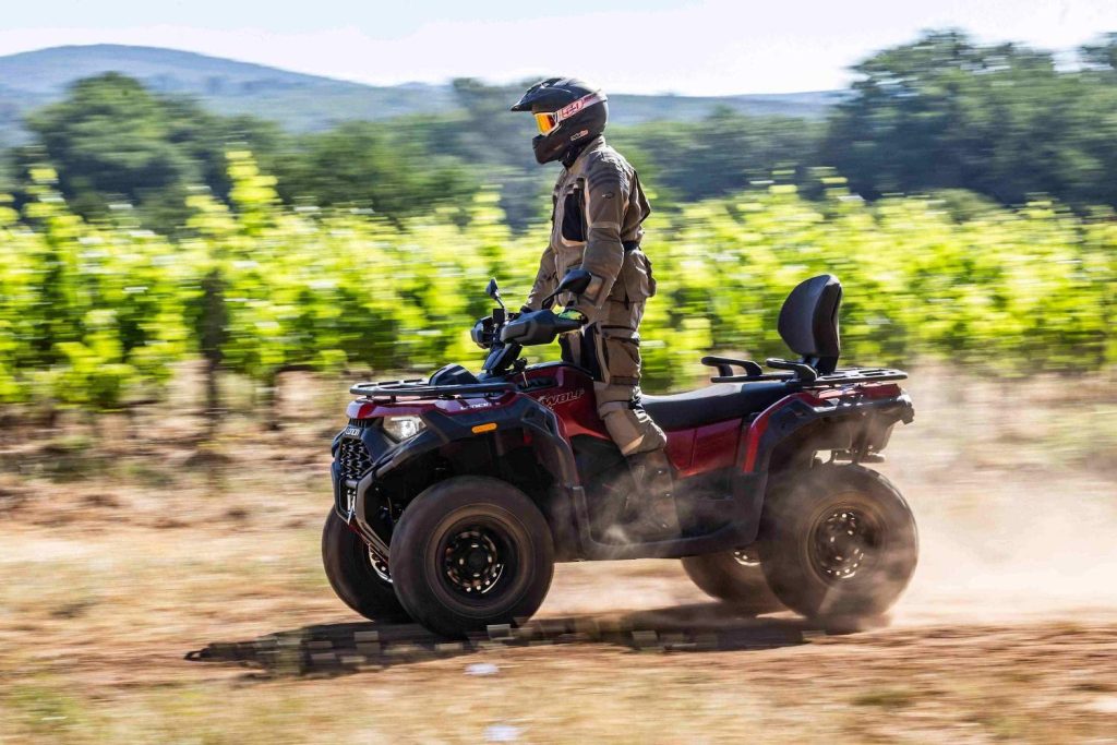 How to Choose a Hunting ATV for Different Terrains? 2 Hunting ATV fully equipped with gear navigating complex off-road terrain