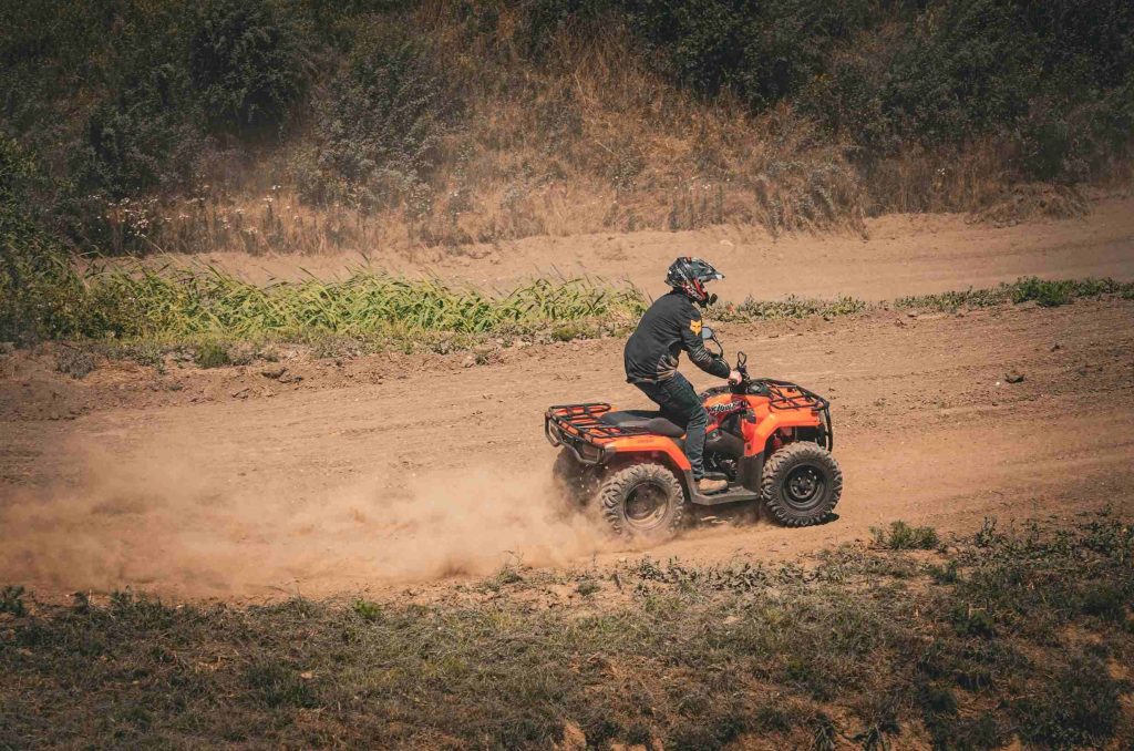 How to Choose a Hunting ATV for Different Terrains? 3 LONCIN XWOLF300 ATV maneuvering through narrow forest trails